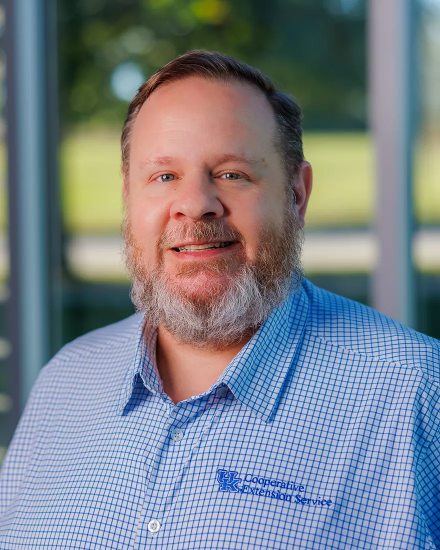 Picture of man in a blue shirt with University of Kentucky logo, Photo of Dr. Mark Mains