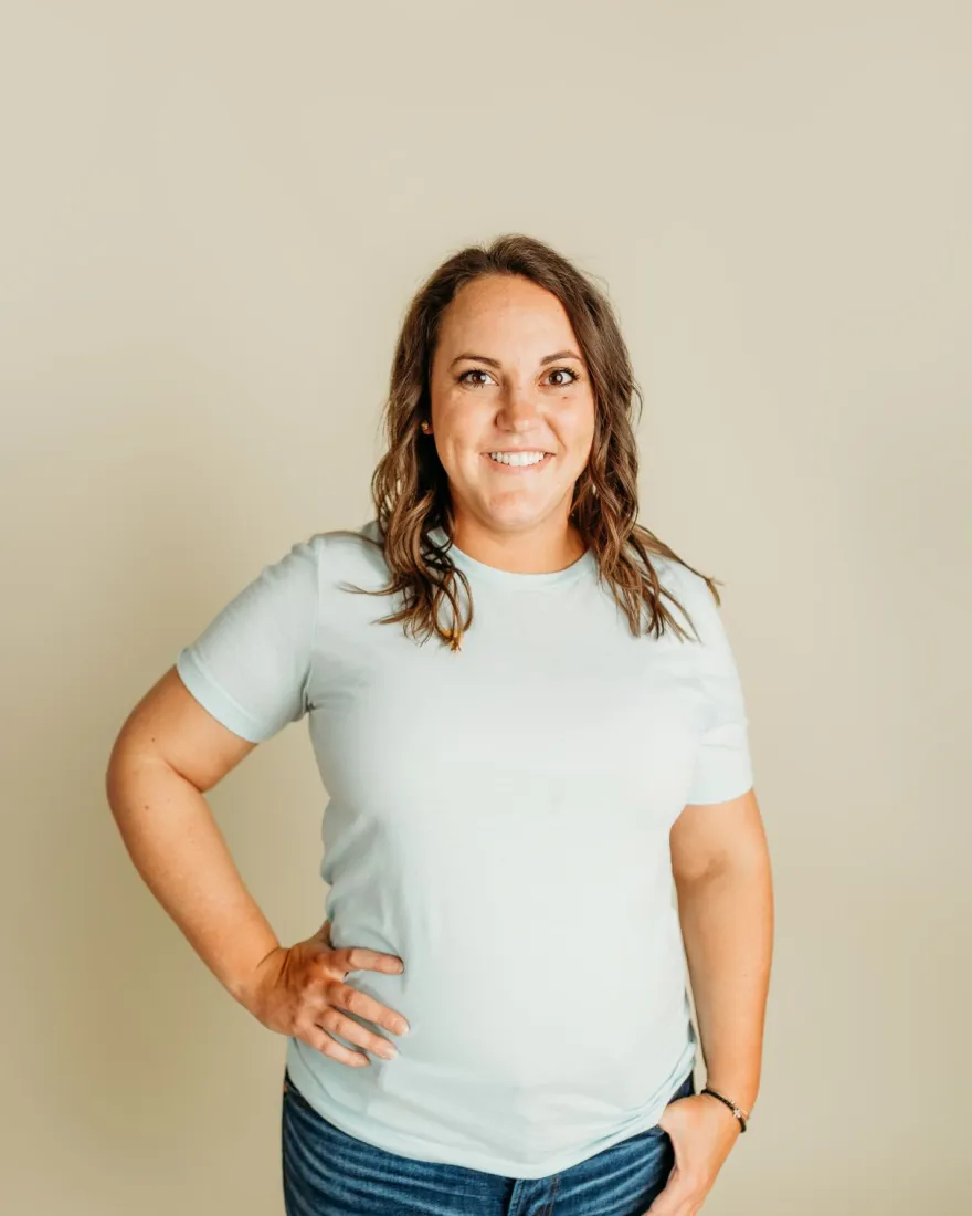 girl with brown hair in blue shirt and jeans