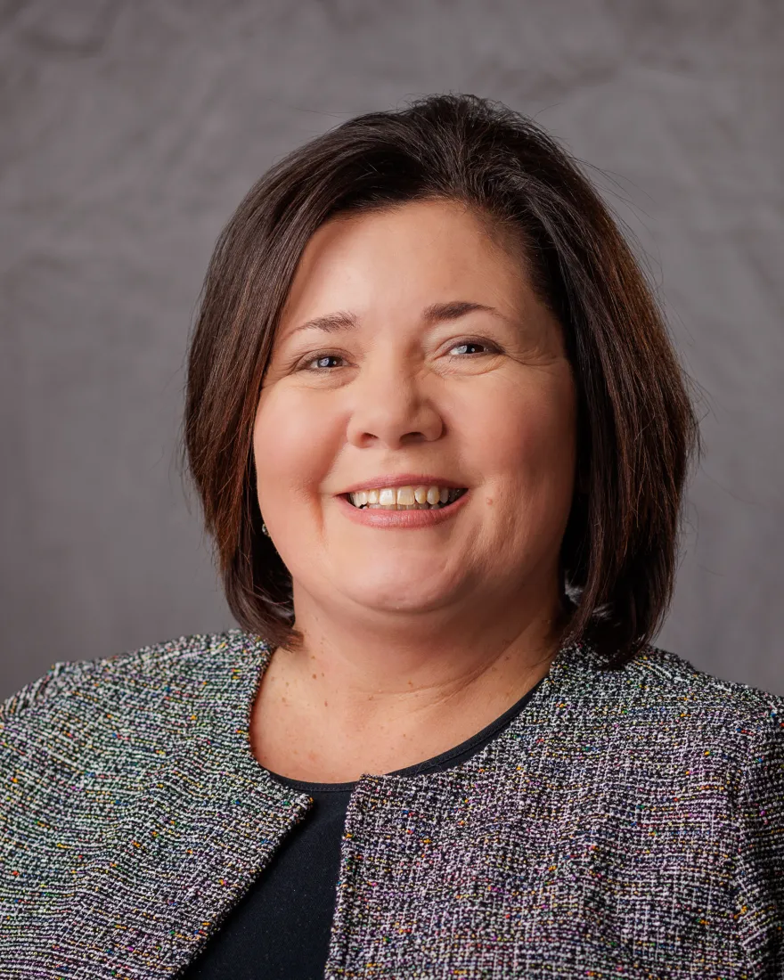  Professional headshot of a woman with a slight smile.